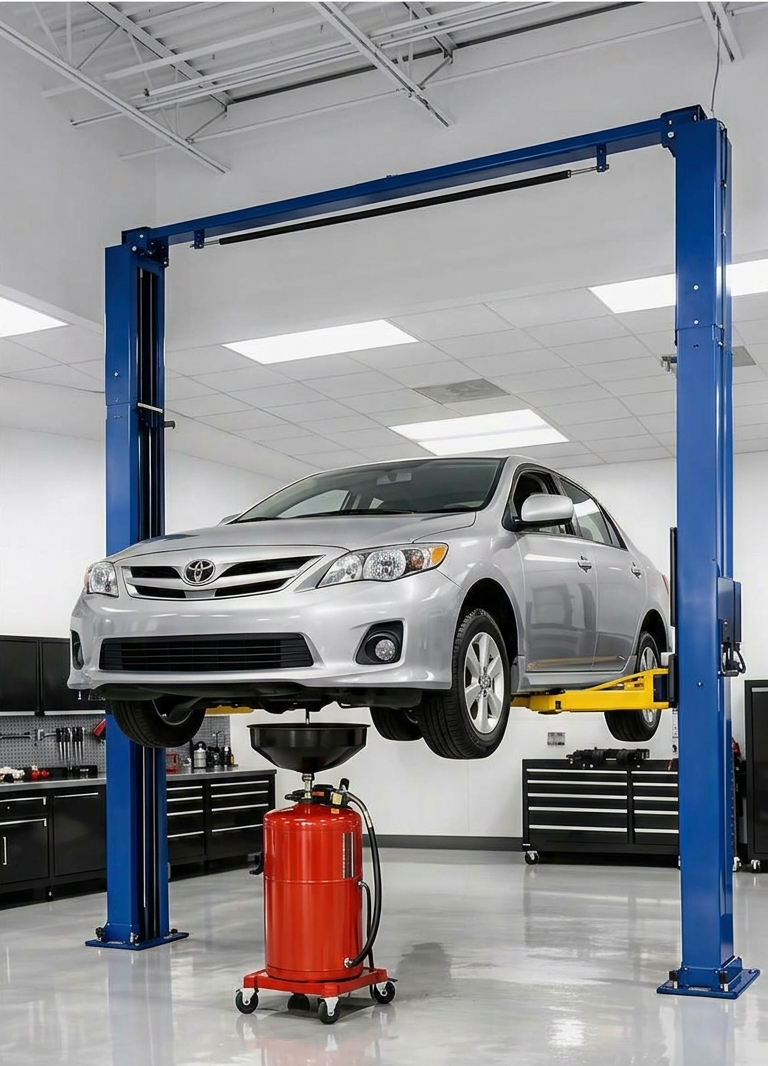 A silver Toyota Corolla sedan raised on a vehicle lift in a modern workshop, ready for service